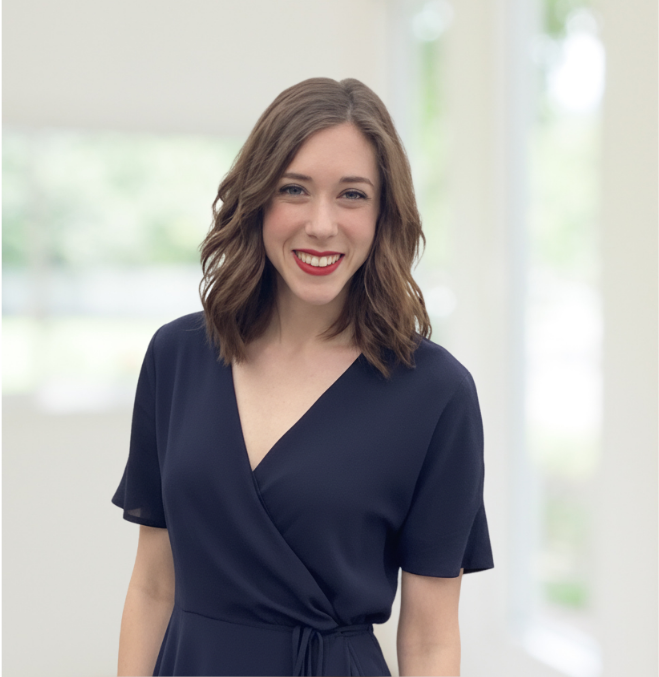 Smiling caucasian woman with shoulder-length brown hair, wearing a dark short-sleeved dress.